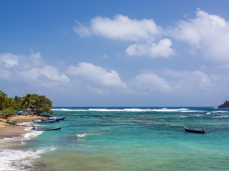 Canoes perch in a sea with different shades of blue. Enjoy the hidden beaches in the region.