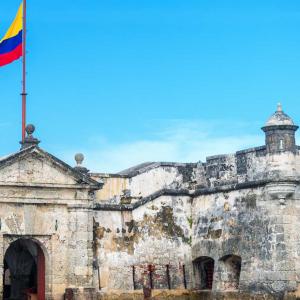Walls of Cartagena with Colombia flag and blue sky