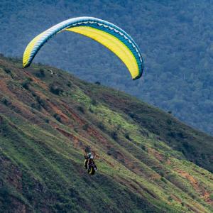 Tourist practicing paragliding adventure tourism in Chicamocha park, San Gil, Santander.